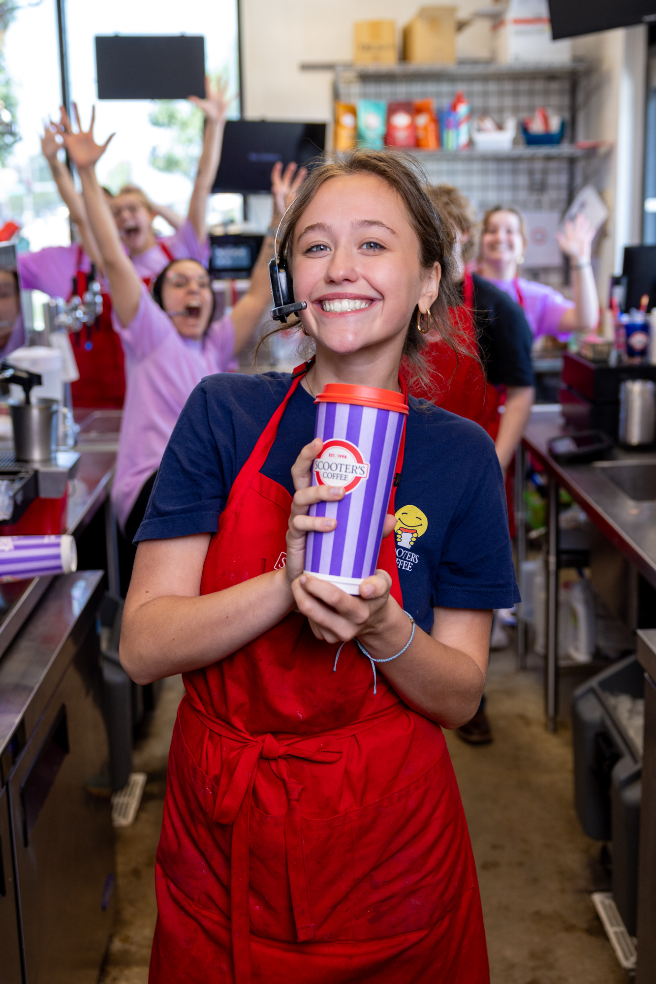 Scooter’s Coffee barista inside a kiosk